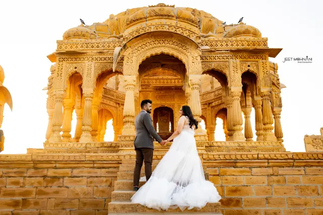 The couple on the steps of a sandstone haveli in Jaisalmer