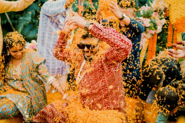 The groom under a shower of marigold