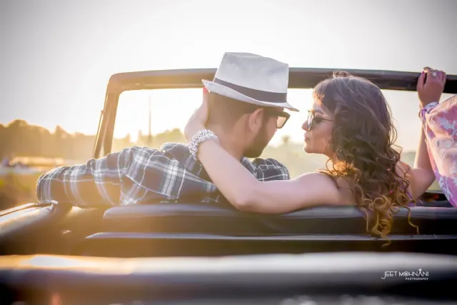 The couple in an open jeep on the way to the shoot