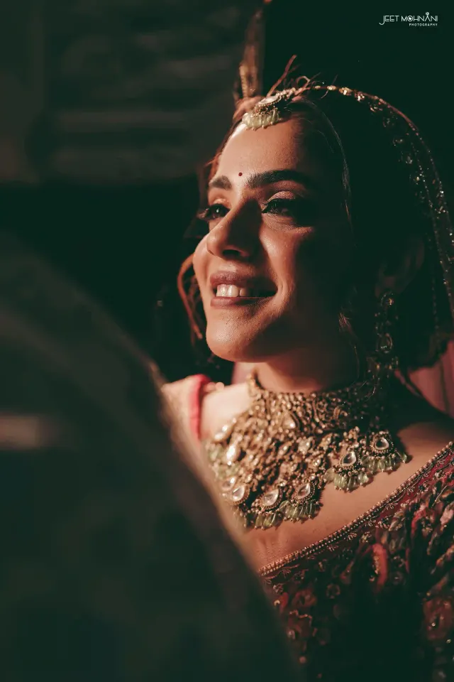 The bride in close portrait, her jewellery catching the light